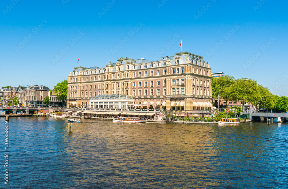 Amsterdam, May 7 2018 - the famous five star Amstelhotel at the river Amstel in summertime - obrazy, fototapety, plakaty 