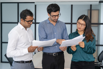 Wall Mural - Multiethnic business team analyzing financial reports