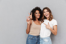 Portrait Of Two Cheerful Young Women Standing Together