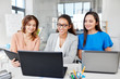 © Syda Productions - business, teamwork and people concept - female team or businesswomen with tablet pc and laptop computers working at office