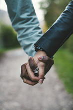 Cropped Image Of Couple Holding Hands At Park