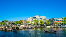 Amsterdam, May 7 2018 - View On The River Amstel Filled With Small Boats And The Carre Theater In The Background On A Summer Day