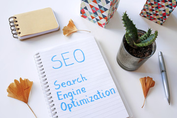 Wall Mural - SEO Search Engine Optimization written in notebook on white table