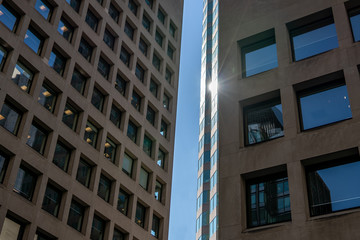 Sunlight reflecting off glass between two office buildings