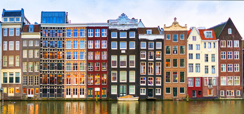 Amsterdam, The Netherlands, May 4th 2017:  Row of authentic canal houses on the Rokin in Amsterdam - obrazy, fototapety, plakaty 