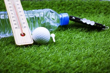 Golf ball and water and thermostat for the heat in Summer , for golfer dehydrate concept