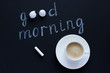 © IRINA - Text Good morning with chalk on black background cup coffee and