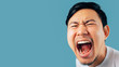 Face of Asian man shout and scream on isolated background.