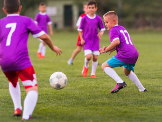 Young children players football match on soccer field