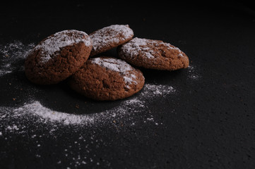 Wall Mural - oatmeal cookies on a black table in castor sugar