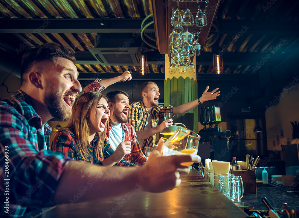 Sport, people, leisure, friendship and entertainment concept - happy football fans or male friends drinking beer and celebrating victory at bar or pub - obrazy, fototapety, plakaty 