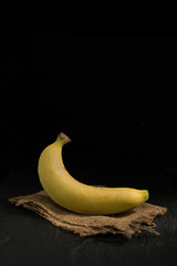 Wall Mural - Banana against a dark background