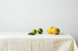 © The Picture Pantry - Minimalistic composition with citrus fruits on a table covered with white linen tablecloth