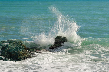 Wall Mural - Big waves breaking on the shore with sea foam