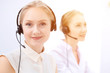 © rogerphoto - Bright  call center office. Two blonde women in a headset
