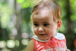 © javiindy - Six months old baby girl smiling outdoors.