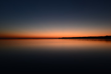 Wall Mural - Twilight sky above the water surface of the lake
