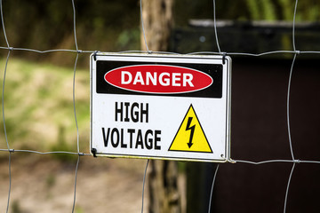 High voltage sign on a fence