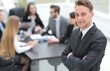 © ASDF - practitioner on the background of business team