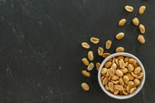 Bowl With Roasted And Salted Peanuts On A Slate With Copy Space