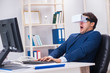 © Elnur - Employee using virtual reality glasses in office