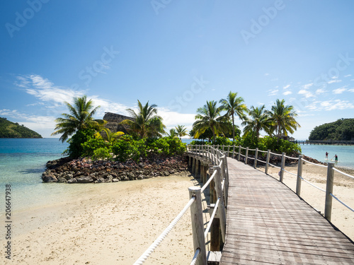 Ocean Landscape Boardwalk Walkway Over Beach out to Lone Palm Tree Island in Fij Tableau sur Toile