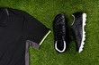 football boots and a sports shirt against the background of grass