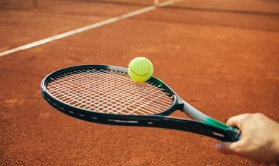 Wall Mural - Tennis racket and ball on the clay court