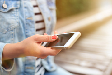 Wall Mural - Close up of a woman using mobile smart phone.