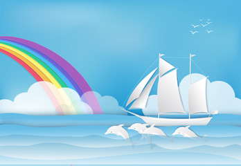 Wall Mural - Sailing ship with Dolphin in the sea and rainbow on blue sky background