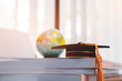 Graduated or Graduation university study abroad international Conceptual, Master cap on books stack with blur of america earth world globe model map in Library room of campus, Back to School