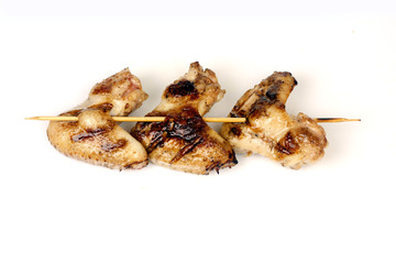 Wall Mural - chicken wings fried on a grill strung on a skewer