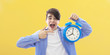 young person with clock or alarm, concept of time and punctuality