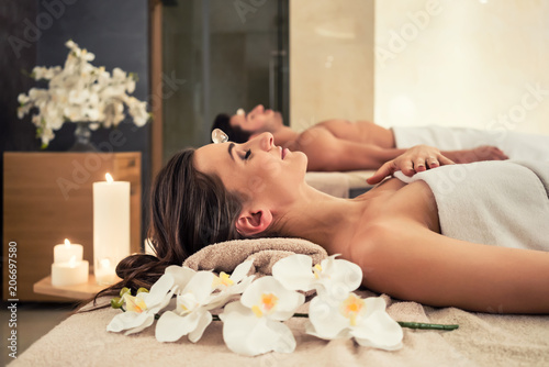 young-man-relaxing-with-his-partner-on-massage-beds-at-modern-spa-and-wellness-center