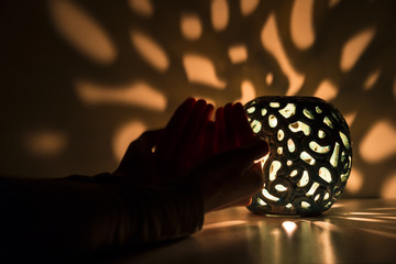 A person praying to God under soft light for Ramadan,world peace and health. Friday message concept or religious background photo. 