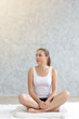 © thbangkok - Young caucasian very attractive woman practicing yoga, sitting in Padmasana doing yoga exercise or Lotus pose or namaste pose. Working out on her bed.