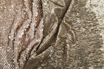 two gold crumpled fabrics of shiny pieces