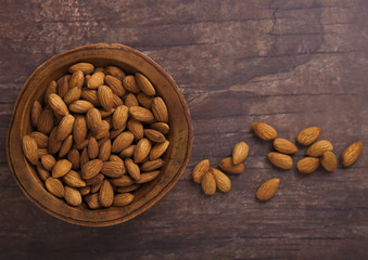 Wooden bowl with fresh raw almond nuts