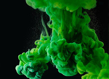 Close-up View Of Green Abstract Paint Explosion On Black Background