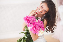 Very Beautiful Young Woman With Flowers. Portrait Of Attractive Girl With Peonies