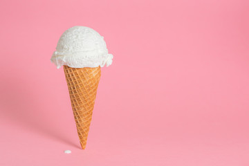 summer funny creative concept of wafer cone with melting ice cream on pink background, copy space