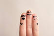 Fingers with drawings of happy faces against light background. Unity concept