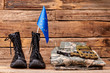 © DenisProduction.com - Set of military outfit of european union soldier. Brown wooden desk surface background.