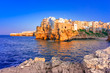 Polignano a Mare, Puglia, Italy: Sunset at Cala Paura gulf with Bastione di Santo Stefano and Lama Monachile beach in background, Apulia, Italy, province of Bari