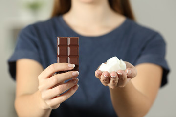 Woman hands showing sugar and chocolate