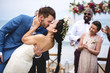Cheerful newlyweds at beach wedding ceremnoy