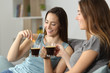© Antonioguillem - Women drinking coffee throwing sugar into cup