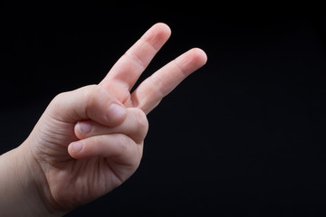 Hand showing the sign of victory and peace