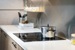 Metal Pot on induction hob in modern kitchen. modern kitchen pot cooking induction electrical stove hob concept