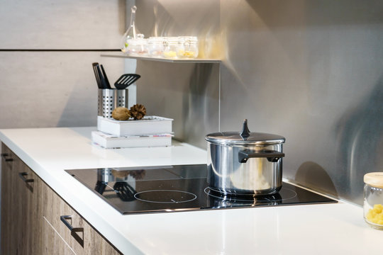 metal pot on induction hob in modern kitchen. modern kitchen pot cooking induction electrical stove 
